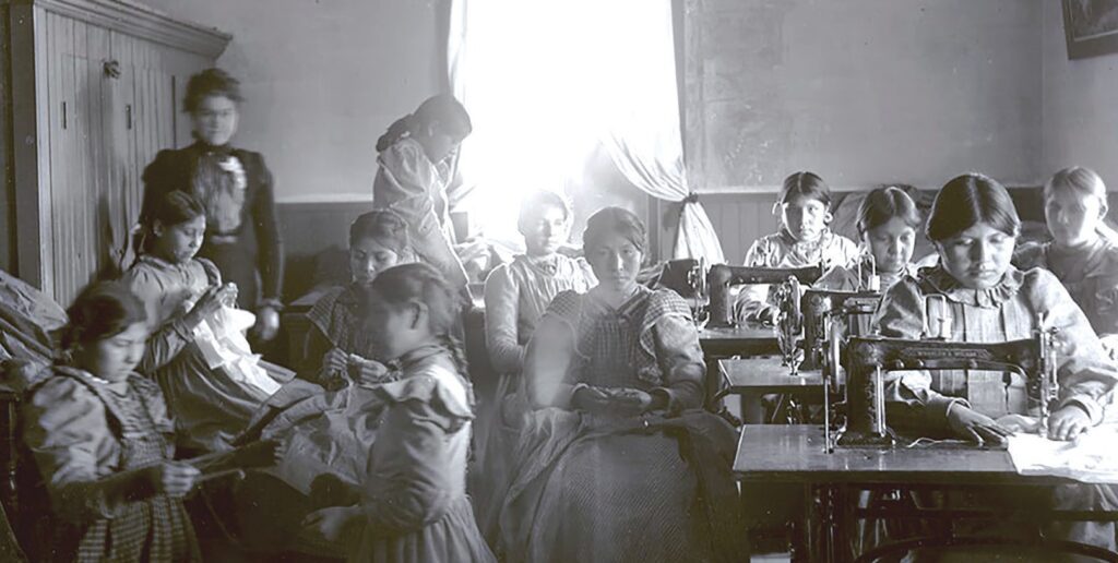 In an undated photo, children are seen in the sewing department at Cut Bank Boarding School in Montana. The school was also known as the Blackfeet Agency Boarding and Day School. (Sherburne/Mansfield Library, Archives & Special Collections)