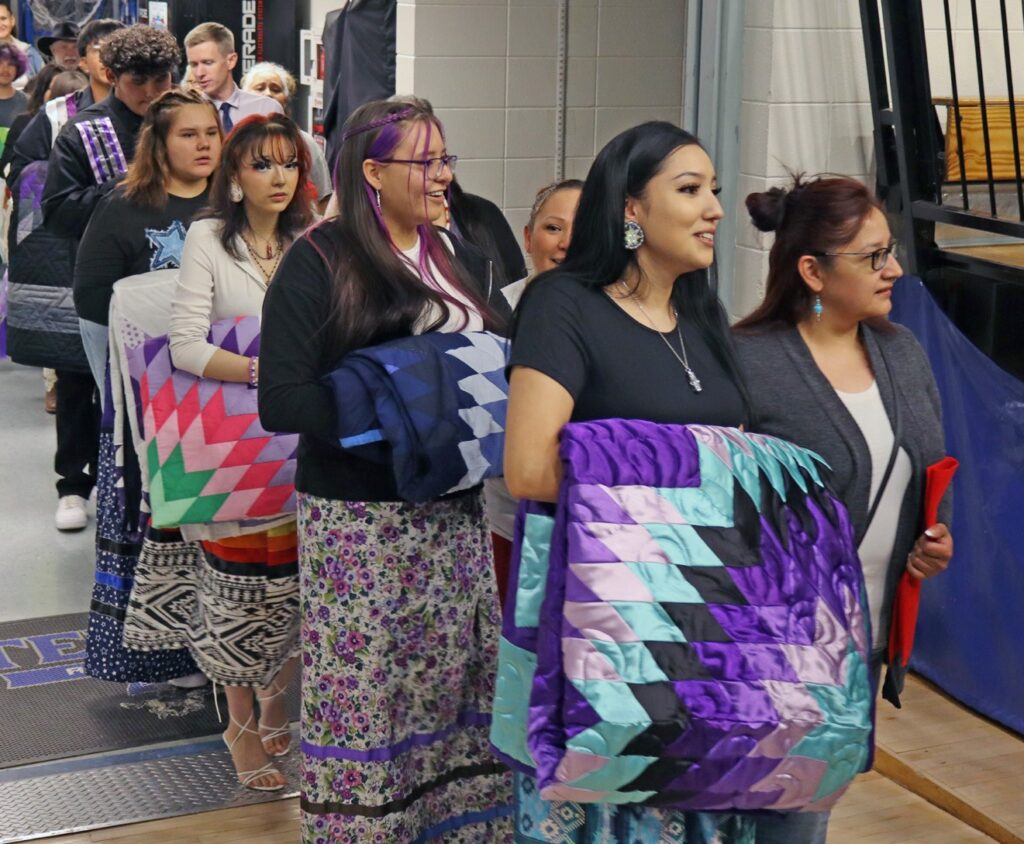 Seniors stand in line for the Grand Entry at the 2025 Feathering Ceremony. (Photo by Marnie Cook)