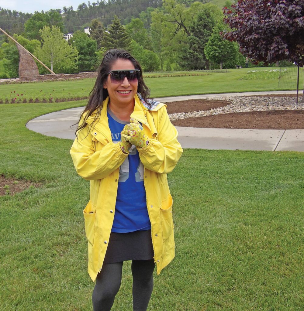 LeFawn Janis standing in front of second flower bed planned for Medicine Wheel planting. Photo by Marnie Cook