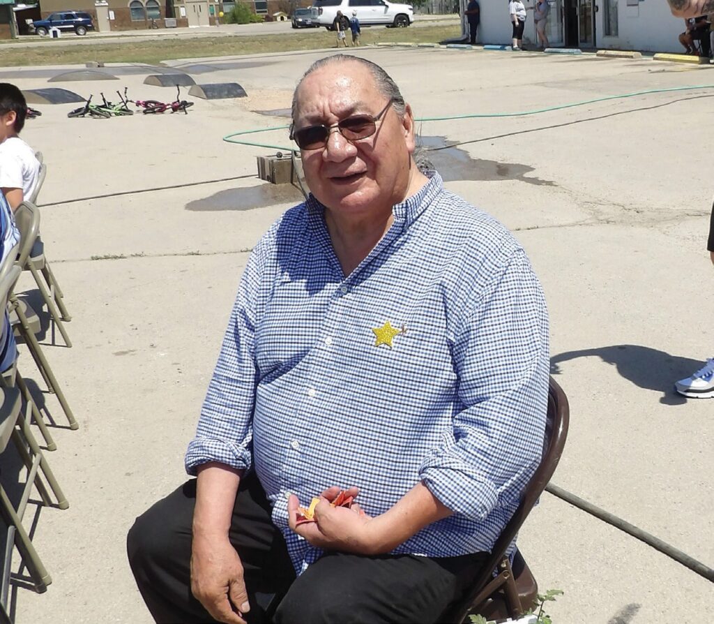 Louis R. Janis after scoring a tomato plant in the raffle. (Photo by Marnie Cook)