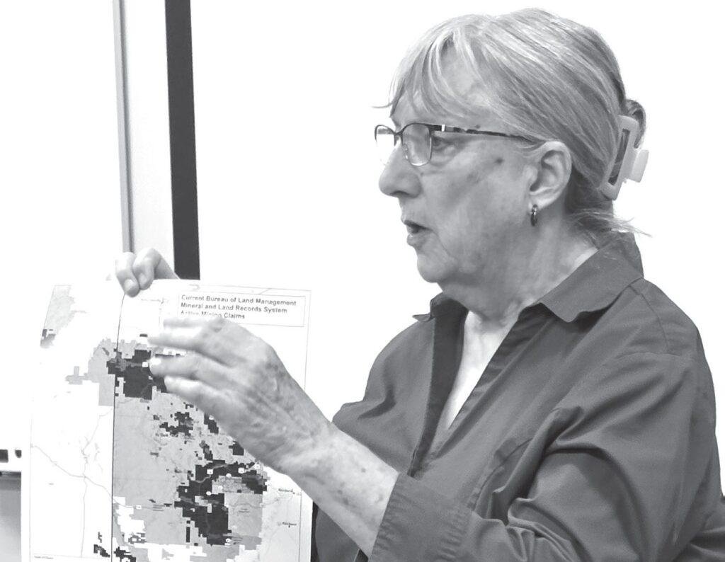 Dr. Lilias Jarding Black Hills Clean Water Alliance executive director explaining the mining projects which are the dark spots on the map. (Photo by Marnie Cook)