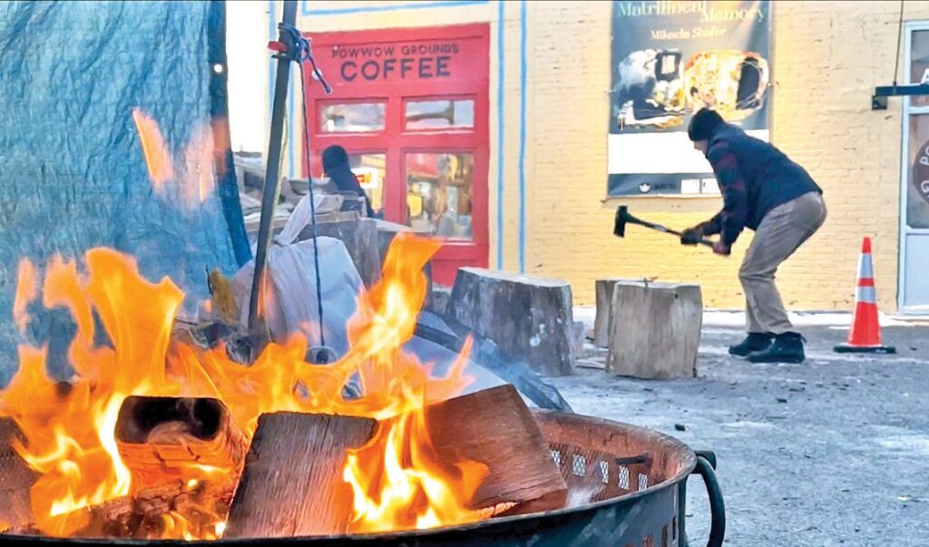 A fire provides a warming station for the Native community and others outside the Powwow Grounds Coffee on Franklin Avenue in Minneapolis on Monday, Jan. 19, 2026. Volunteers are pouring in from across the country to provide patrols and security for Native residents. Credit: Stewart Huntington/ICT