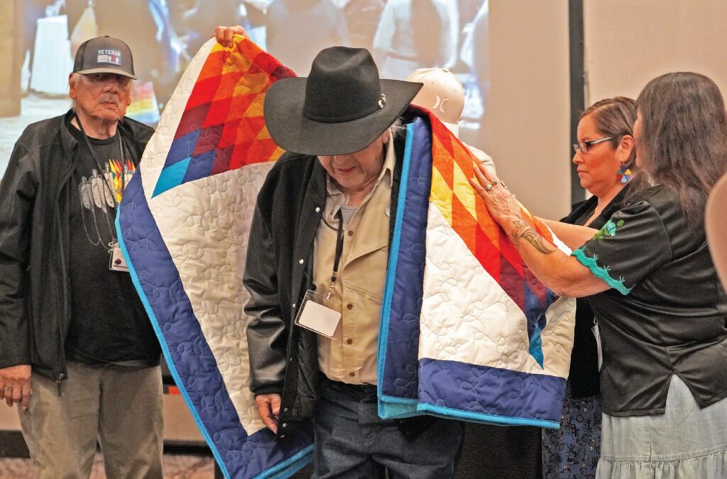 Bill Means was gifted a star quilt by the International Indian Treaty Council and the Oceti Sakowin Treaty Council for his many decades of advocacy for Indigenous people throughout the world. (Photo by Darren Thompson)