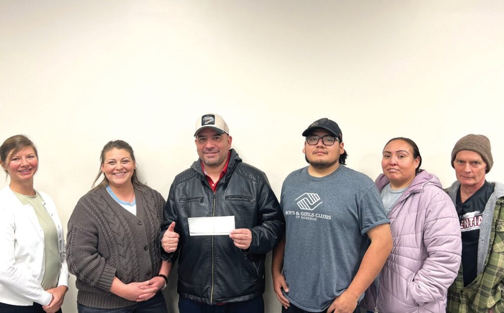 Pictured are (left to right) Boys & Girls Club Executive Director Rachel Kocak, Board Treasurer Serena Harmon, Board Vice Chair Dion Reynolds and staff members Aaron Cordier, Danielle Shot With Two Arrows and Todd Ellendorf.