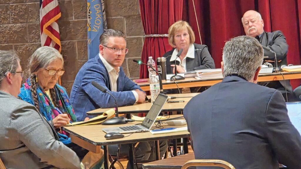 (L. to R.) Assistant to Lakota interpreter Leola One Feather, Mike Blady, board members, tribal attorney Steven Gunn. (Photo by Marnie Cook)