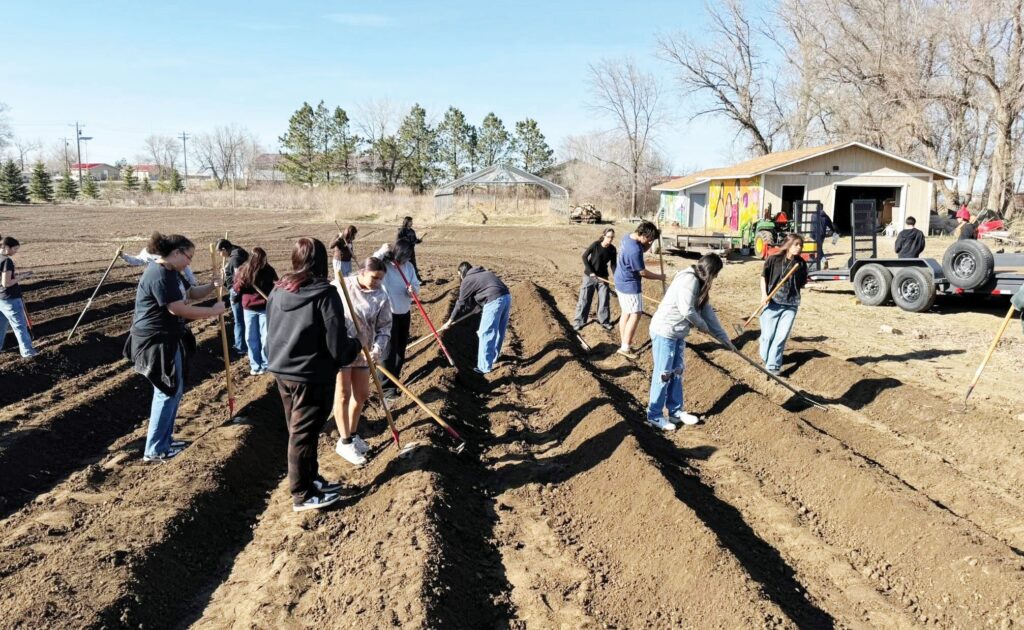 CRYP teen interns help prepare the Winyan Toka Win Garden for the 2026 growing season. (COURTESY PHOTO of CRYP)