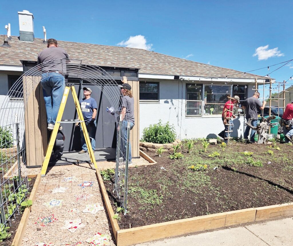 Volunteers from Fountain Springs Church worked throughout the day on improvement projects, including building a shed for the neighborhood’s tool lending library and installing new lighting in the Star Village Community Garden. (Photo by Tyler Reed)