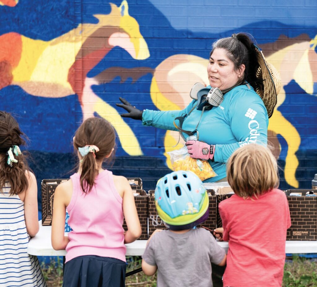 Featured RedCan artist 179 explains her techniques and imagery to youth during RedCan 2025.