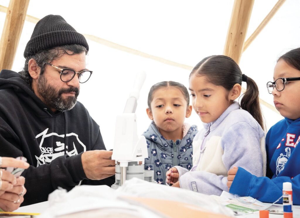 Featured RedCan artist J.Duh leads a youth workshop inside a tipi during RedCan 2025.