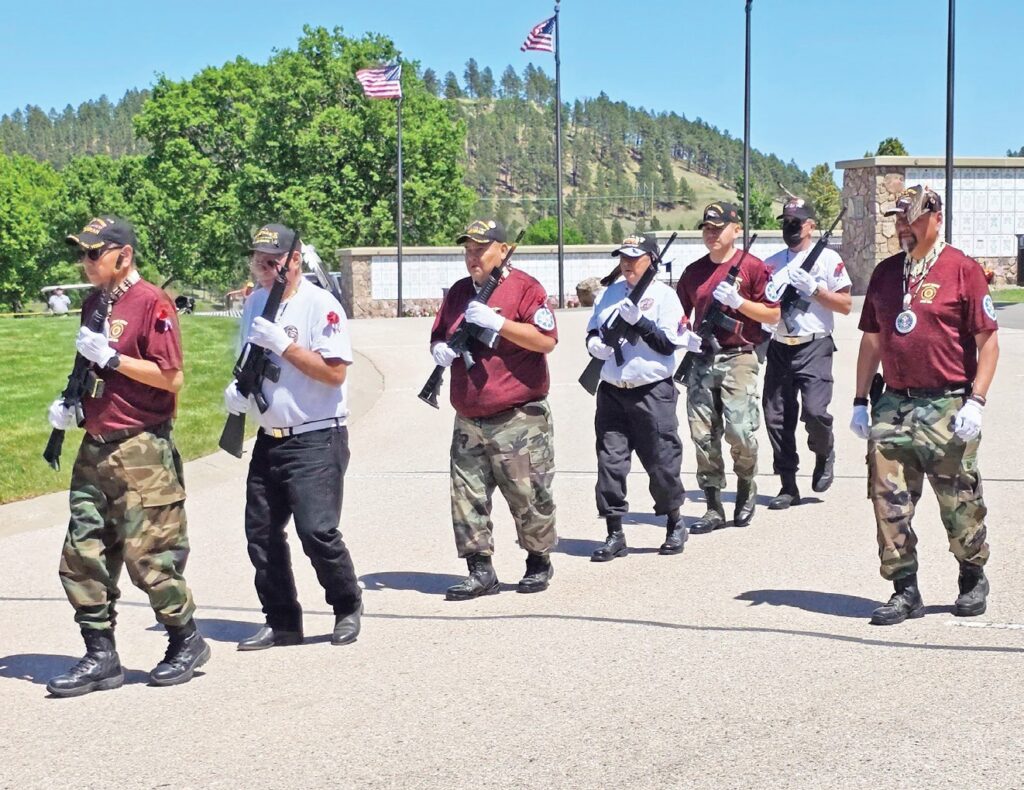 Lakota veterans from all tribes render 21 gun salute. (Photo by Marnie Cook.)