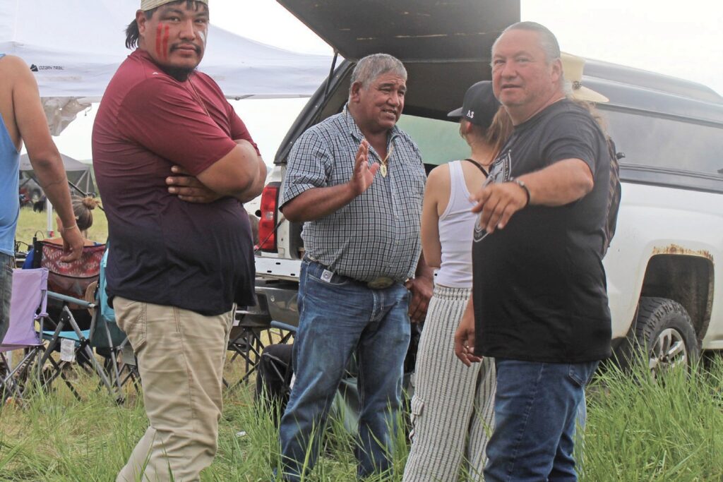 Former Cheyenne River Sioux Tribal Chairman Harold Frazier, who rode horseback with fellow Cheyenne River riders to Greasy Grass, visits with Frankie Jamerson, former vice president of the Standing Rock Sioux Tribe, at Pezi Sla, newly purchased Cheyenne River land. (Photo by Ernestine Anunkasan Hopa)